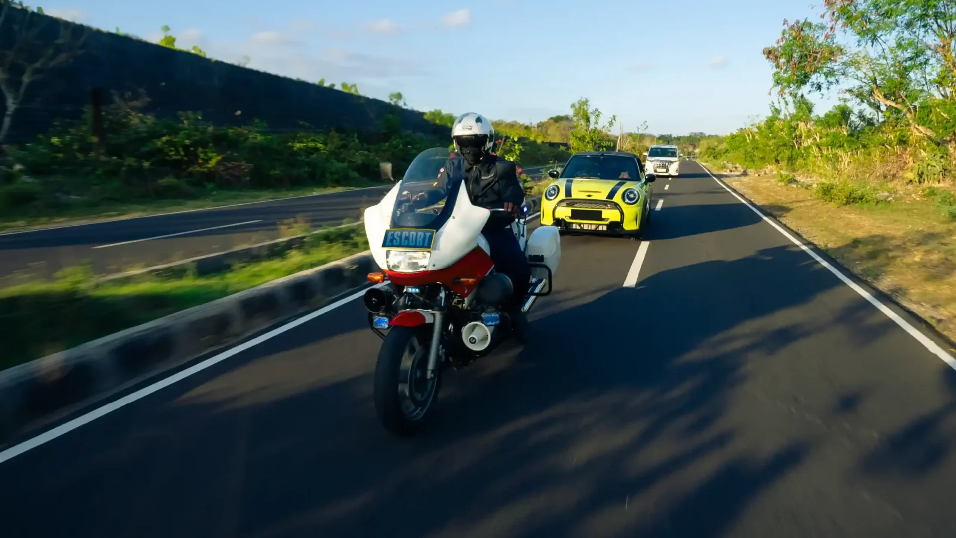 Police escort motorbike leading a convoy in Bali
