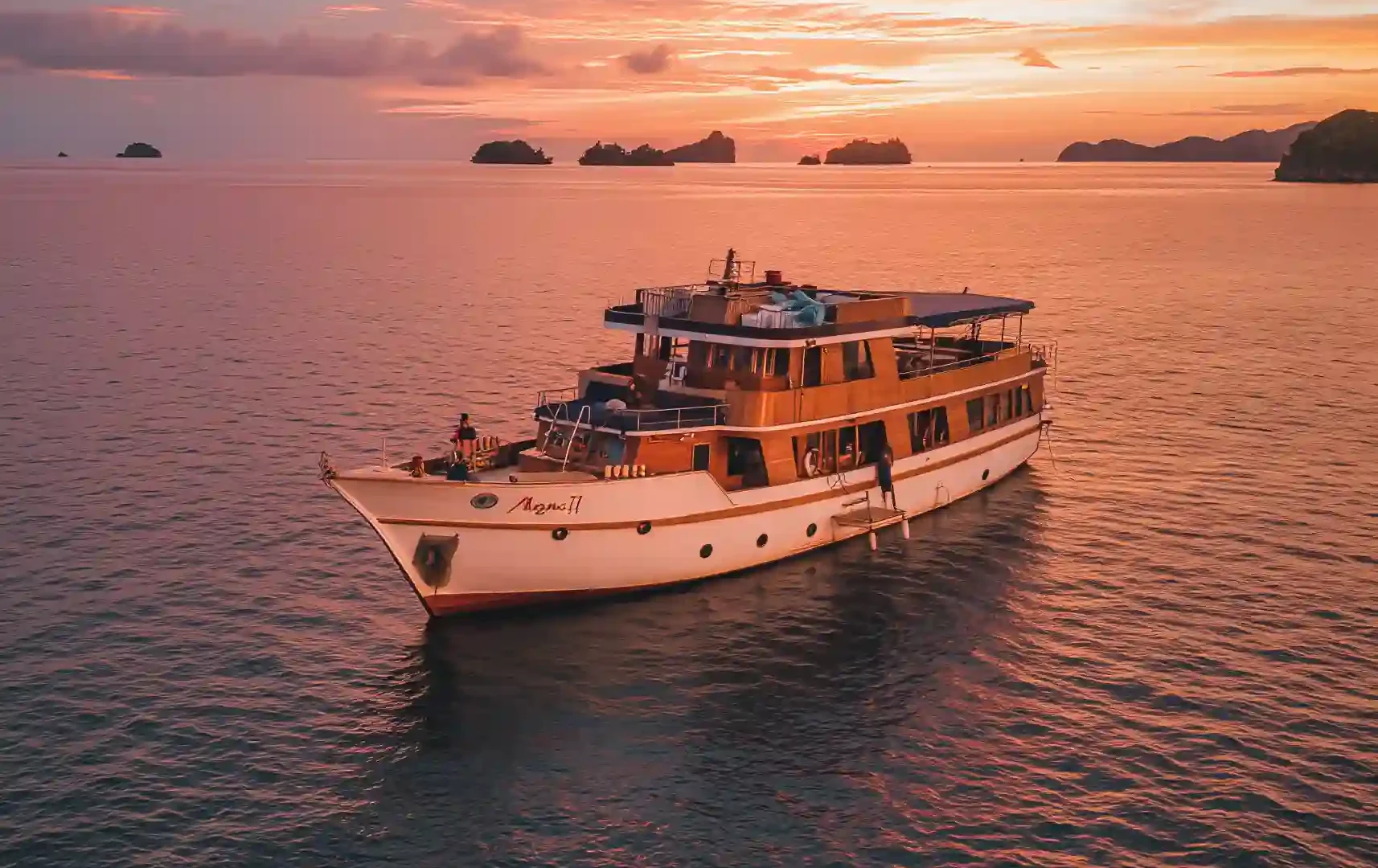 Motor yacht at sunset off the Komodo coast