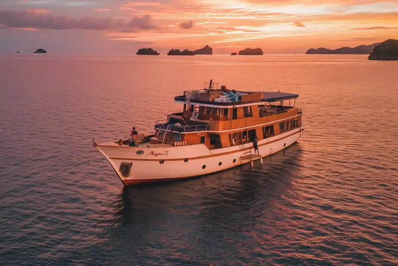 Motor yacht at sunset off the Komodo coast